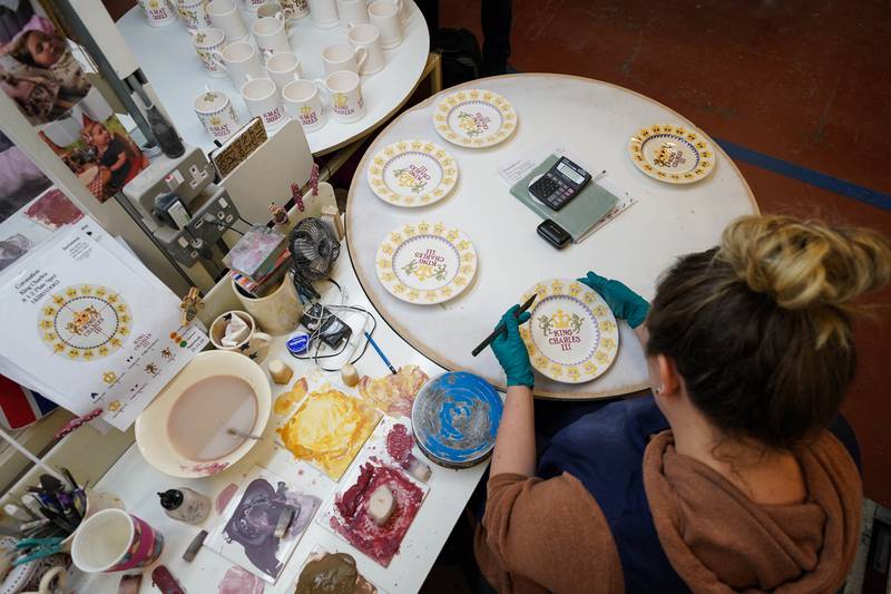 Detail is added to plates, pieces from the King Charles III Coronation collection, at the Emma Bridgewater Pottery Factory in Stoke on Trent. Photo: Jacob King