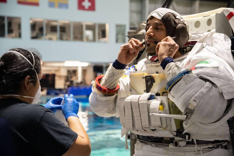 Sultan Al Neyadi, part of the UAE astronaut corps, wears his EVA suit for spacewalk training in the indoor pool 