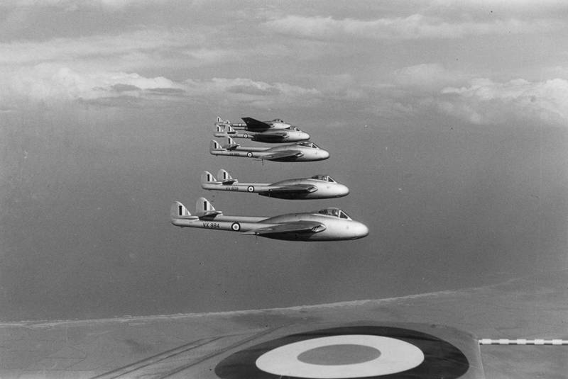 A formation of RAF de Havilland Vampire jets in flight at the Farnborough Airshow in 1950.