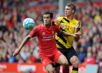 Philippe Coutinho, left, of Liverpool and Lukasz Piszczek of Borussia Dortmund battle for the ball during the Pre Season Friendly match between Liverpool and Borussia Dortmund at Anfield on August 10, 2014 in Liverpool, England. Clint Hughes/Getty Images