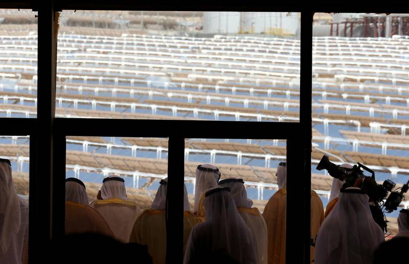 TO GO WITH STORY BY ALI KHALIL
UAE officials are seen from behind a glass door as they look from a balcony at the Shams 1, Concentrated Solar power (CSP) plant, in al-Gharibiyah district on the outskirts of Abu Dhabi, on March 17, 2013 during the inauguration of the facility. Oil-rich Abu Dhabi officially opened the world's largest Concentrated Solar Power (CSP) plant, which cost $600 million to build and will provide electricity to 20,000 homes. AFP PHOTO/MARWAN NAAMANI (Photo by MARWAN NAAMANI / AFP)