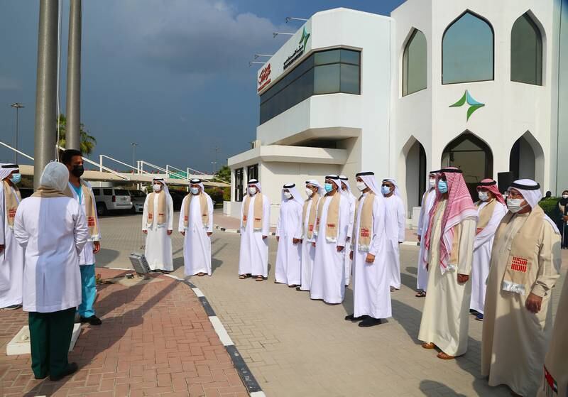 Workers at Dubai Health mark the occasion.