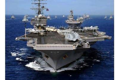 The nuclear-powered "supercarrier" USS Ronald Reagan, with other US Navy vessels. A letter-writer says that much of the blame for the enormous US national debt rests with the country's endless military spending. EPA