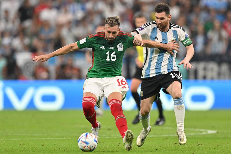 Mexico midfielder  Hector Herrera fights for the ball with Lionel Messi. AFP