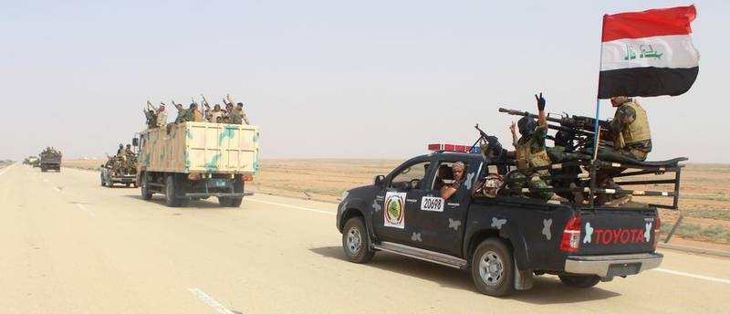 Iraqi government forces and local tribal fighters drive on the highway between the city of Ramadi and the town of Rutba as they take part in an operation to retake Rutba from ISIL on May 16, 2016. AFP / MOADH AL-DULAIMI

