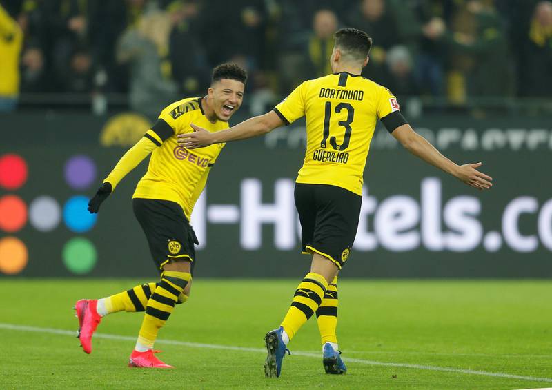 Borussia Dortmund's Raphael Guerreiro celebrates scoring their first goal with Jadon Sancho. Reuters