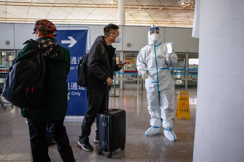 Passengers present their health information before departure at the Beijing Capital International Airport on November 30. The airport has since dropped its Covid rules. EPA