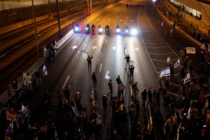 Protesters block a road during a demonstration in Tel Aviv on Saturday as Israeli Prime Minister Benjamin Netanyahu's government presses on with its contentious judicial overhaul. Reuters