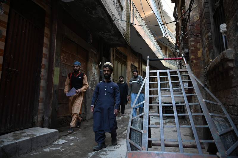 Pakistani waiter Rozi Khan walks on a street in Rawalpindi. AFP