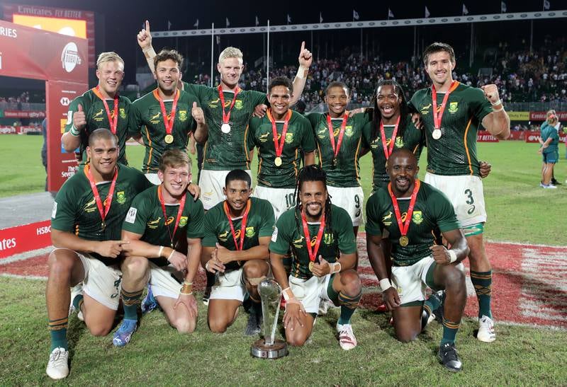 South Africa celebrate with the trophy after winning the World Series title at the Dubai Sevens. Photos by Chris Whiteoak / The National