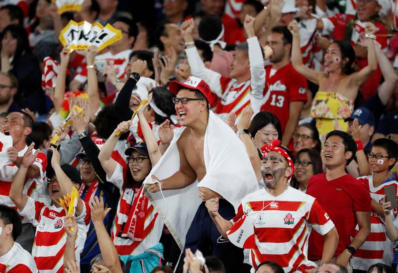 Japan fans celebrate their team's first try. Reuters