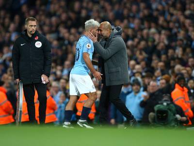 Manchester City's coach Pep Guardiola, right, reacts, as Manchester City's Sergio Aguero walks off after being substituted. AP Photo