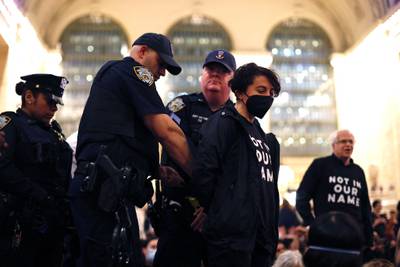 NYPD officers arrest a protester during the demonstration at Grand Central Station in New York City on Friday. AFP