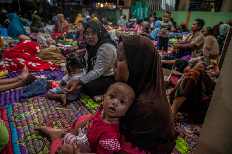 People take shelter in a community hall in Candipuro village, East Java. AFP