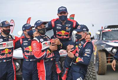 TOPSHOT - French driver Stephane Peterhansel celebrates with teammates following his victory in the Dakar Rally in Saudi Arabia, on January 15, 2021. / AFP / FRANCK FIFE
