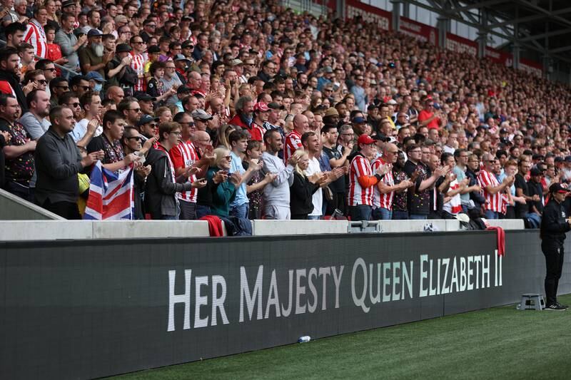 Fans at Brentford's Gtech Community Stadium applaud in a tribute to Her Majesty Queen Elizabeth II, who died at Balmoral Castle on September 8, 2022. Getty 