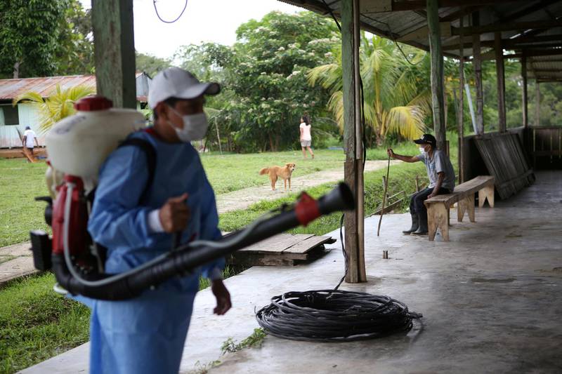 A worker disinfects an area before it is set up as a vaccination centre to administer the Pfizer-BioNTech vaccine, in the Santa Maria de Ojial community, in Iquitos, Peru. Reuters