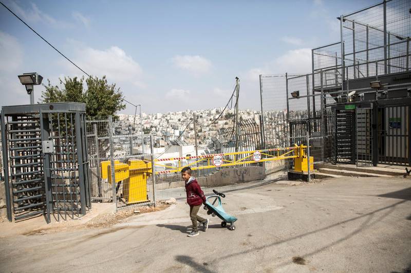 A Palestinian child by an Israeli checkpoint in the Palestinian Tel Rumeida neighborhood, which, along with three other Hebron enclaves houses 800 illegal settlers who live among its 200,000 Palestinians.Hebron . The Israeli government opened an archeological park nearby . (Photo by Heidi Levine for The National).