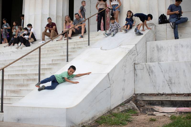 James Vongue, 8, slides down a marble structure next to stairs at the Lincoln Memorial in Washington. Reuters