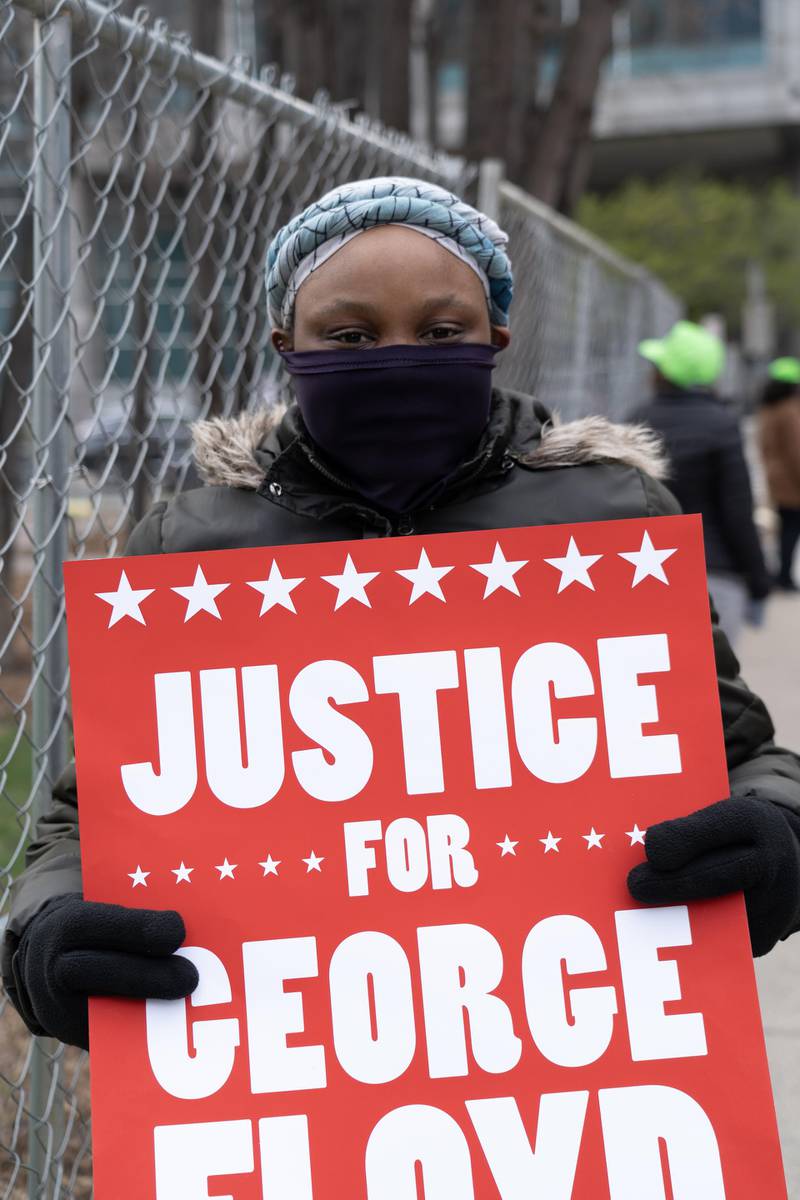 Kiara Durham, 20, holds a sign at a march in downtown Minneapolis. Willy Lowry / The National