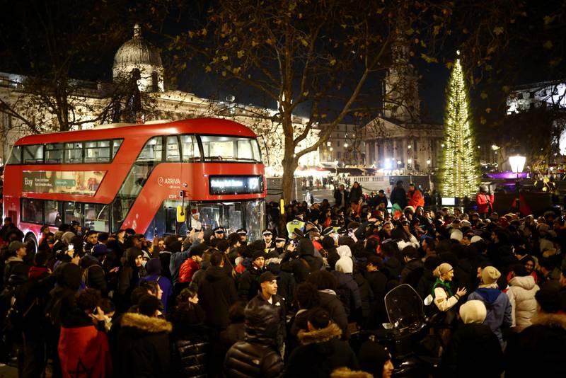 Fans block a bus in Trafalgar Square, London. Reuters