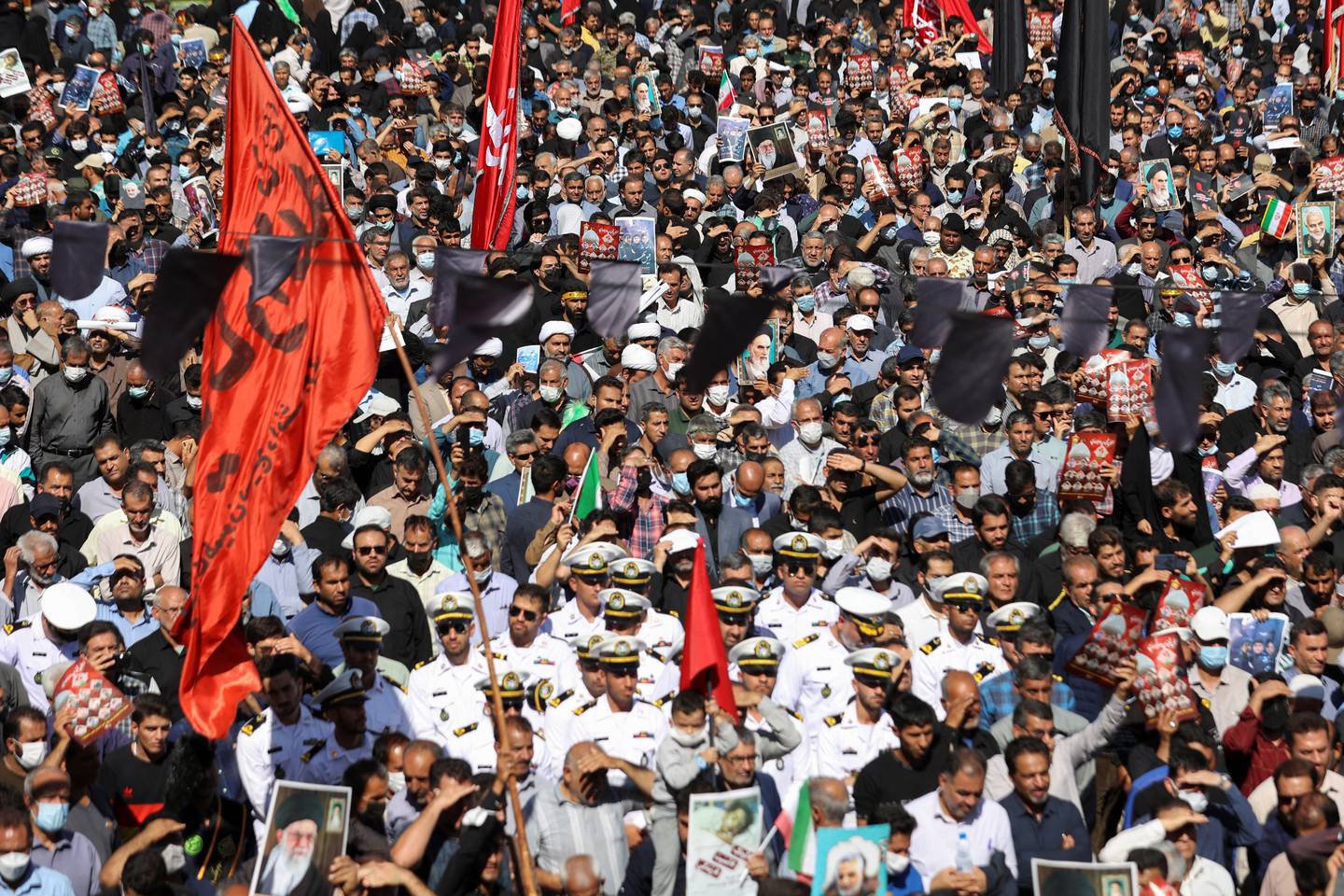 Iranians gather around during a funeral ceremony of the people killed in the Shah Cheragh Shrine attack. WANA via Reuters