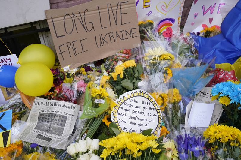 Flowers and messages are piled together outside the Ukrainian embassy in Washington. AP