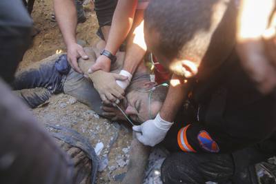 An injured man is rescued from the rubble of a building following an Israeli airstrike in Rafah, Gaza Strip. AP