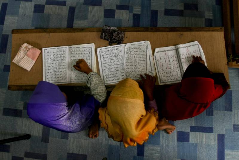 Children recite from the holy Quran at a school. Daniel Chan  / AP Photo