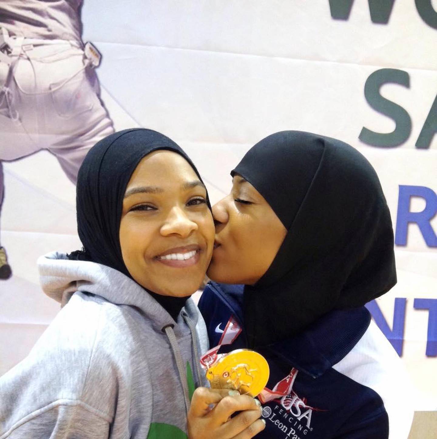 Muhammad's sister Faizah gives her a congratulatory kiss after a competition. 