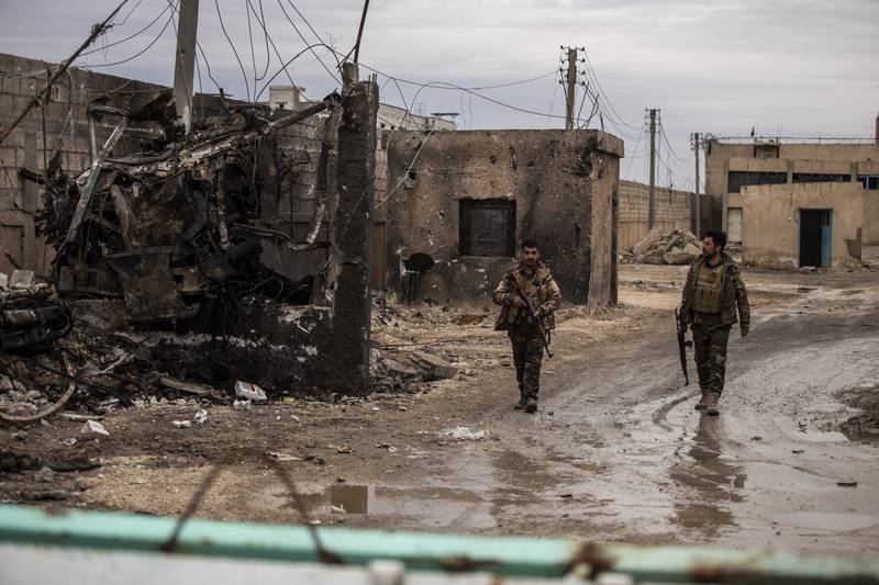 Syrian Democratic soldiers on patrol near theprison attacked by ISIS in Hassakeh, Syria. AP