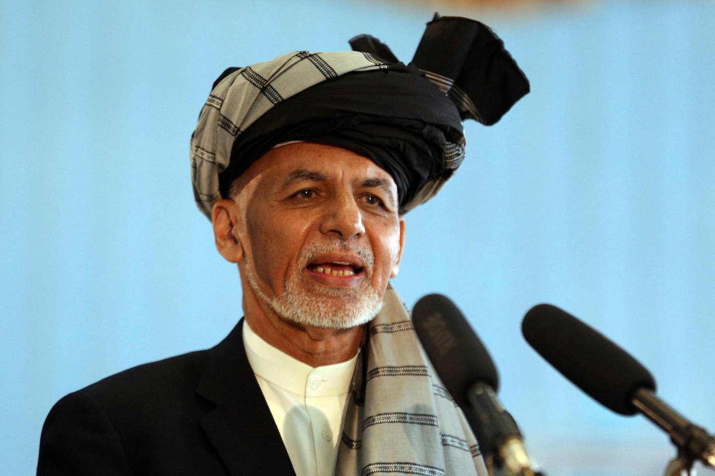 FILE - In this Sept. 28, 2019, file photo, Afghan President Ashraf Ghani speaks to journalists after voting at Amani high school, near the presidential palace in Kabul, Afghanistan. President Ghani said Tuesday, Nov. 12, his government has released three Taliban figures in effort to have the insurgents free an American and an Australian professor they abducted in 2017. (AP Photo/Rahmat Gul, File)