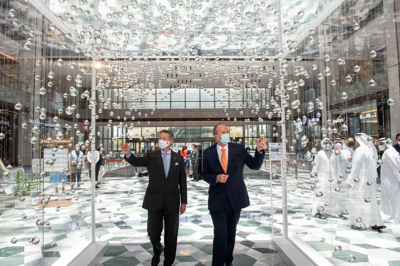 Massimo Baggi, Switzerland ambassador to the UAE and Bahrain, and David Robinson, general manager at The Galleria Al Maryah Island, walk through the Swiss Fog Magnified installation. Courtesy The Galleria Al Maryah Island