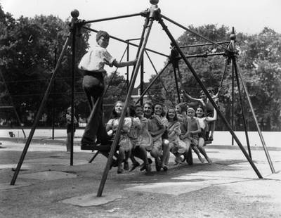 4th August 1947:  Children playing on the swing at Coram's Field Playground, Bloomsbury, London.  (Photo by Topical Press Agency/Getty Images)