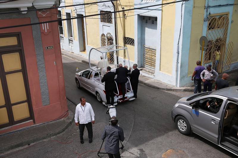 SANTIAGO DE CUBA, CUBA - SEPTEMBER 22:  Pope Francis drives away in his Popemobile after leaving the cathedral where he held a mass and blessed the city on September 22, 2015 in Santiago de Cuba, Cuba. Pope Francis leaves for the United States after spending four days in Cuba.  (Photo by Joe Raedle/Getty Images)
