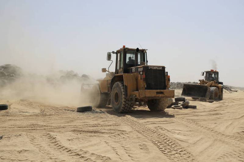 Earth-moving equipment is used to manage the huge volume of old tyres at the site.