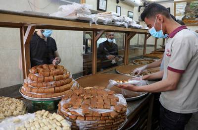 A worker sells sweets to customers in Beirut, Lebanon. Reuters