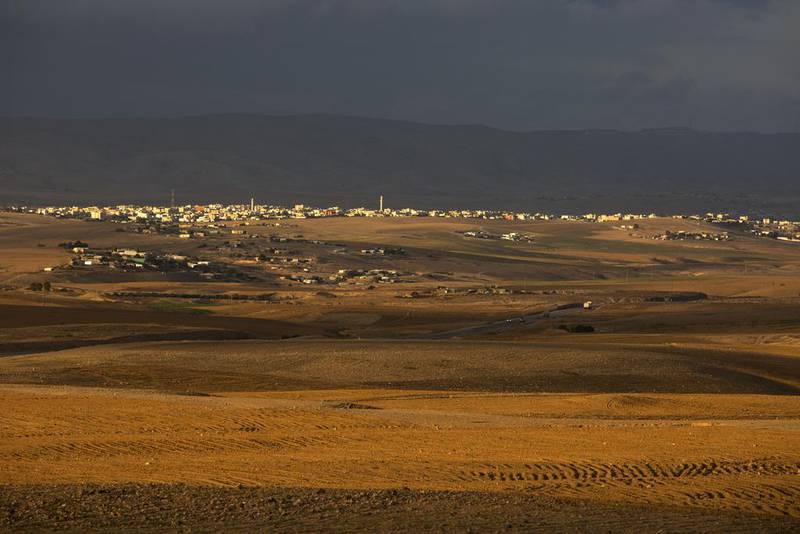 Bedouin communities are seen in the distance located near a highway in Israel’s Negev Desert on December 1, 2015. Israeli rights groups and Beduin leaders fear there could be evictions of Arab residents when the Israeli government carries out its plan to build new Jewish neighbourhoods nad a planned community in Qatamat.