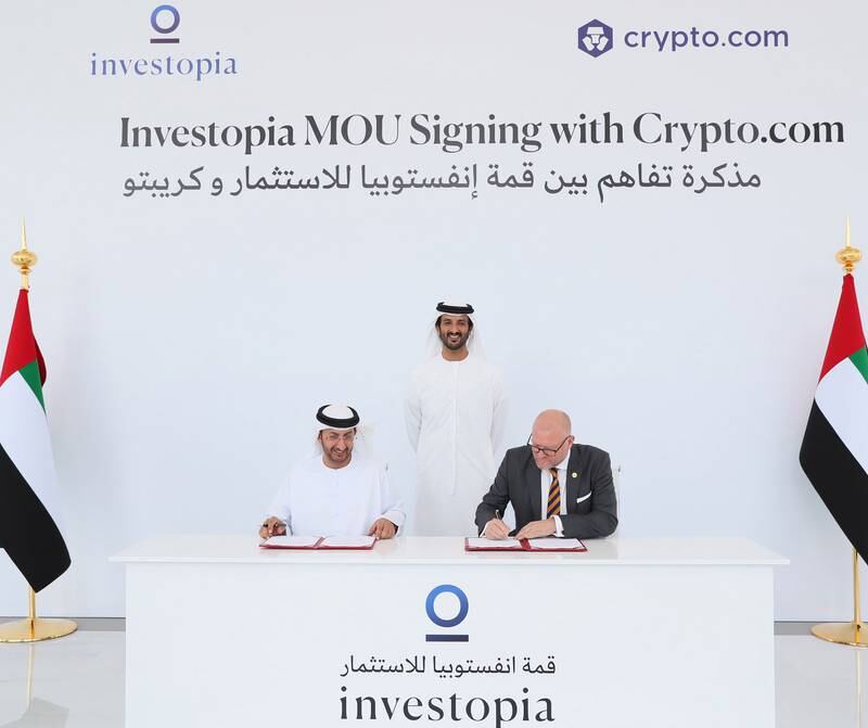 Abdulla bin Touq, Minister of Economy, looks on as Abdullah Al Saleh, undersecretary of the Ministry of Economy, and Stuart Isted, managing director of Middle East and Africa at Crypto.com, sign an agreement between Investopia Summit and the cryptocurrency platform. Photo: Minister of Economy