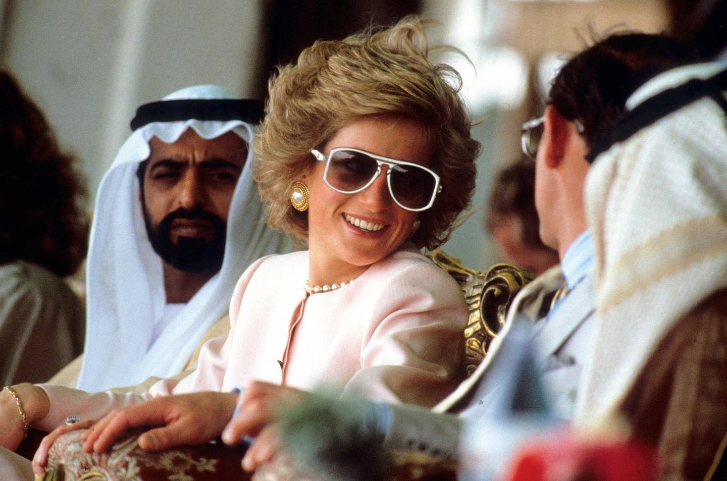 Diana, Princess of Wales and Prince Charles, Prince of Wales watch camel racing during a visit to Abu Dhabi, UAE in March 1989. On left is Sheikh Nahayan & on right (back to camera) is Sheikh Tahnoun.Photo:  Anwar Hussein