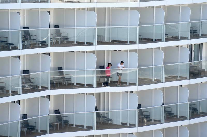 Passengers look out from the 'Spectrum of the Seas' cruise ship docked in Hong Kong. AP
