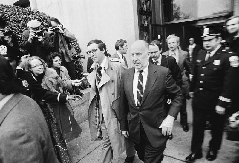 John Mitchell, one of six people charged in the Watergate scandal, walks outside US District Court in Washington on March 9, 1974, where he faced arraignment. Mitchell was eventually convicted of conspiracy, perjury and obstruction of justice related to the Watergate scandal that brought down President Richard Nixon. AP