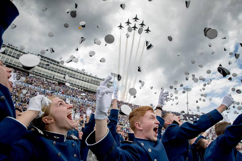 United States Air Force Academy cadets toss their hats in the air as the Thunderbirds fly overhead during the cadets' graduation ceremony at Falcon Stadium in Colorado Springs. AP Photo