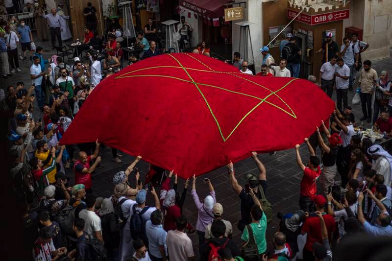 Fans of Morocco cheer at the Souq Waqif market, Doha. EPA