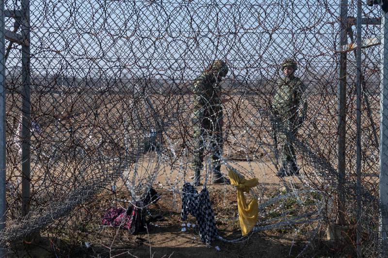 Greek border guards stands behind the border fences in Edirne, Turkey. Getty Images