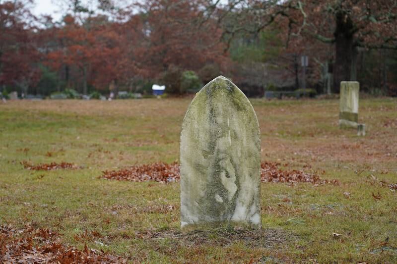 A tombstone at the Old Indian Cemetery in Mashpee, Massachusetts. The Wampanoag have been using the cemetery since the 1700s. Willy Lowry / The National