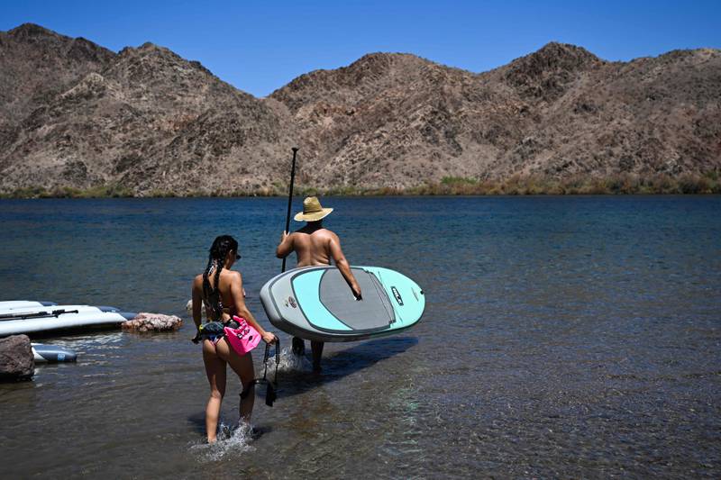 People paddleboard at Willow Beach in the Lake Mead National Recreation Area. Lake Mead is the largest reservoir in the US but is shrinking at a terrifying rate and now stands just one quarter full. AFP