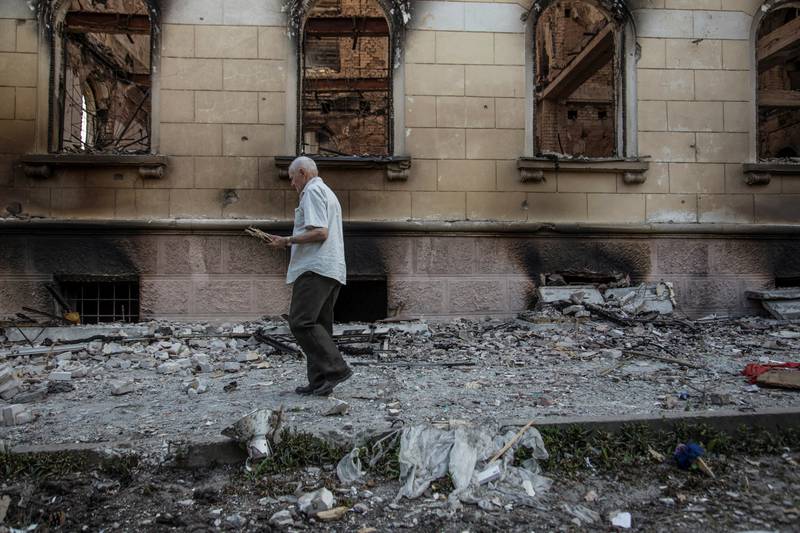 A man walks next to a damaged building in Lysychansk. Reuters