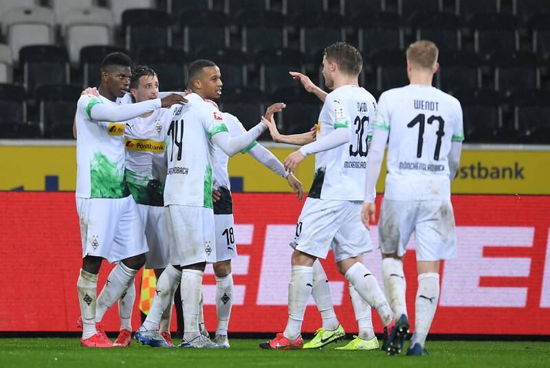 MOENCHENGLADBACH, GERMANY - MARCH 11: Breel Embolo of Borussia Monchengladbach celebrates his sides second goal with Alassane Plea, Stefan Lainer, Raffael and other team mates after a 1. FC Koeln own goal during the Bundesliga match between Borussia Moenchengladbach and 1. FC Koeln at Borussia-Park on March 11, 2020 in Moenchengladbach, Germany. For the first time in the history of the German Bundesliga the match is played behind closed doors as a precaution against the spread of COVID-19 (Coronavirus). (Photo by JÃ¶rg SchÃ¼ler/Bongarts/Getty Images)