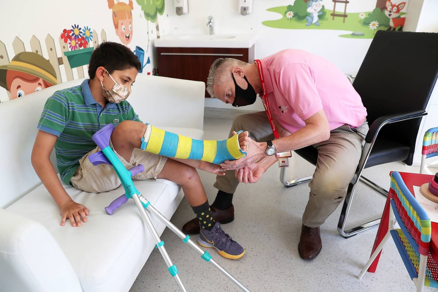 Dr Gavin Spence examines Talal Sawaf's leg, fitted with a 3D printed surgical jig, on 14 September, 2021. Pawan Singh/The National. Full story: https://bit.ly/3HVJ33B